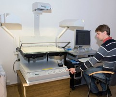 Specialist A. Mazalas is scanning a publication with Bookeye scanner. © D. Mukienė